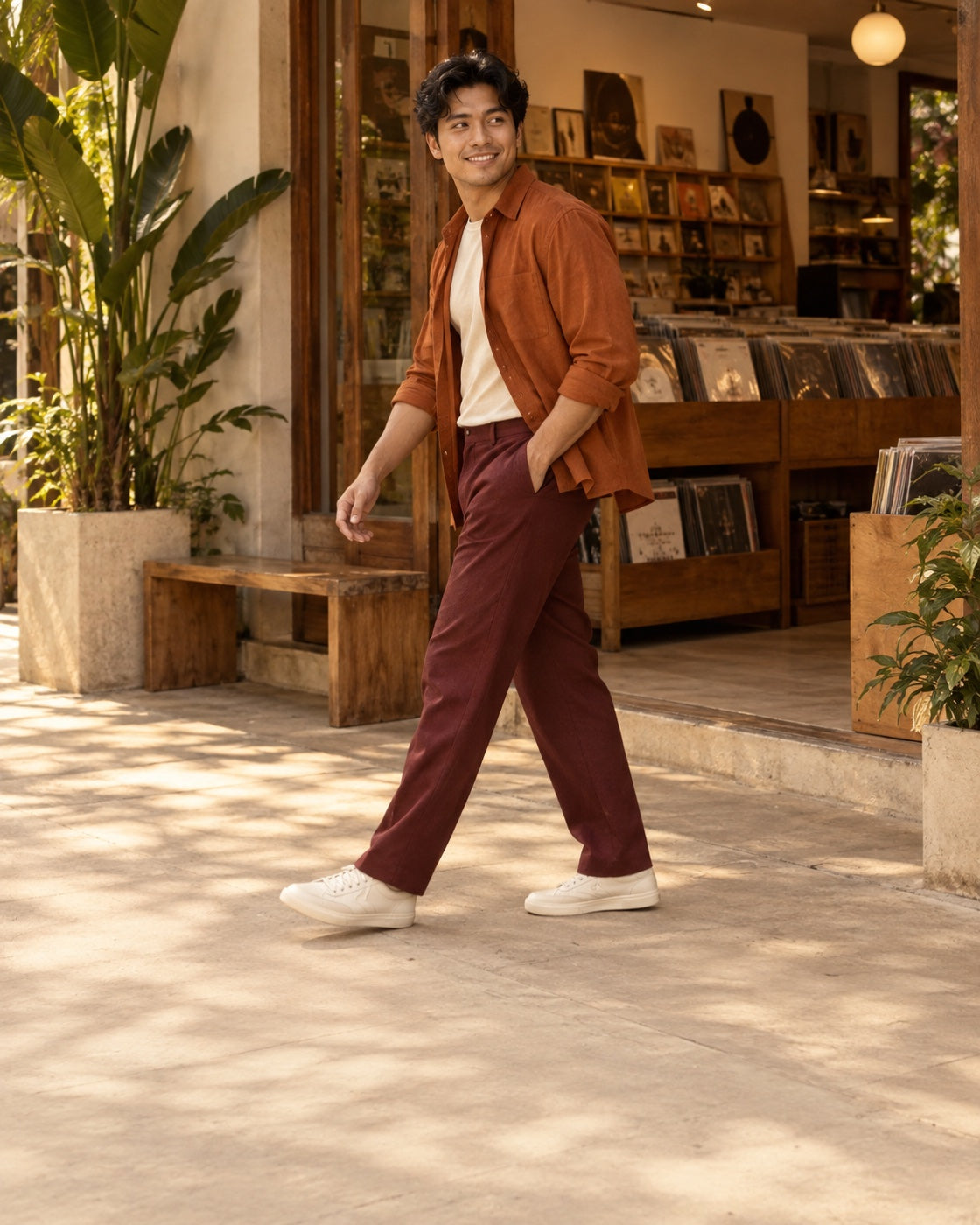 A Filipino man walks past a welcoming record shop in burnt-orange and burgundy