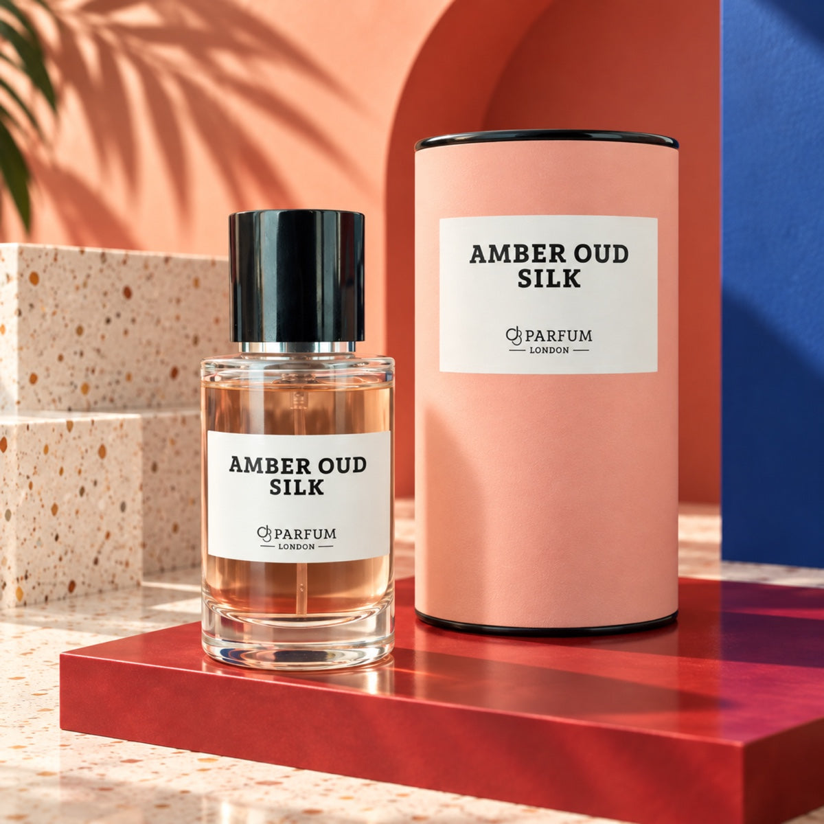 Amber Oud Silk 50 ml fragrance bottle and blush-peach presentation canister